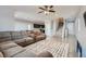 Spacious living room with L-shaped sofa and staircase at 8272 Southern Cross Ave, Las Vegas, NV 89131