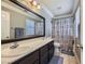 Bathroom with double sinks, dark vanity, and shower/tub combo at 9154 Cazador St, Las Vegas, NV 89123