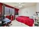 Bright bedroom with red bedding and a workspace at 9154 Cazador St, Las Vegas, NV 89123