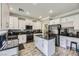 Modern kitchen with white cabinets, granite counters, and stainless steel appliances at 9154 Cazador St, Las Vegas, NV 89123