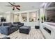 Living room with gray sofas, a large TV, and wood-look floors at 9154 Cazador St, Las Vegas, NV 89123