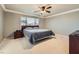 Main bedroom with carpeted floor, ceiling fan, and large bed at 9154 Cazador St, Las Vegas, NV 89123