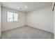 Well-lit bedroom with gray carpet and window with blinds at 9998 Ullom Dr # 16, Las Vegas, NV 89141