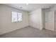 Well-lit bedroom featuring double closets and gray carpet at 9998 Ullom Dr # 16, Las Vegas, NV 89141