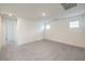 Spacious bedroom with gray carpeting and access to hallway at 9998 Ullom Dr # 16, Las Vegas, NV 89141