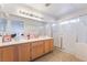 Bathroom with double sinks, large shower, and light wood cabinets at 1005 Siena Hills Ln, Las Vegas, NV 89144