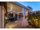 Covered patio with seating area, ceiling fan, and white curtains at 1066 Bootspur Dr, Henderson, NV 89012