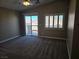 Spacious carpeted bedroom featuring sliding glass door and plantation shutters for added privacy at 1142 Grass Pond Pl # 3, Henderson, NV 89002