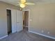 Bedroom features a ceiling fan, neutral carpet and a closet with bi-fold doors at 1142 Grass Pond Pl # 3, Henderson, NV 89002