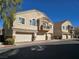 Tan two-story townhouses with attached garages and balconies at 1142 Grass Pond Pl # 3, Henderson, NV 89002