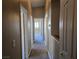 Hallway with neutral carpet leading to a room with a bright window, offering a sense of depth at 1142 Grass Pond Pl # 3, Henderson, NV 89002