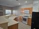 Kitchen featuring sink and range with breakfast bar in an open concept floorplan at 1142 Grass Pond Pl # 3, Henderson, NV 89002