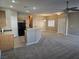 Open-concept living room with view of updated kitchen and flooring at 1142 Grass Pond Pl # 3, Henderson, NV 89002