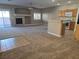 Open living room and kitchen with fireplace and carpet at 1142 Grass Pond Pl # 3, Henderson, NV 89002
