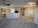 Open-concept living room and kitchen with breakfast bar, ceiling fan, and neutral decor at 1142 Grass Pond Pl # 3, Henderson, NV 89002