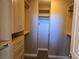Spacious walk-in closet featuring custom wood shelving and drawers for optimal storage at 1142 Grass Pond Pl # 3, Henderson, NV 89002