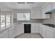 Updated kitchen featuring white cabinets, quartz countertops and tile backsplash at 1252 Little Sidnee Dr, Las Vegas, NV 89123