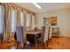 Bright dining room with hardwood floors and large windows at 1349 Via Savona Dr, Henderson, NV 89052