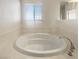 Relaxing bathroom with large, round soaking tub and window at 170 Rolling Fields Ct, Henderson, NV 89012