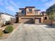 Two-story house with three-car garage and landscaped front yard at 170 Rolling Fields Ct, Henderson, NV 89012
