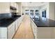 Modern kitchen with an island, dark countertops, and white cabinets at 170 Rolling Fields Ct, Henderson, NV 89012