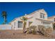 Two-story house with a white exterior, palm trees, and a landscaped yard at 2156 Sun Swept Way, Henderson, NV 89074