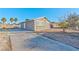 Front view of house with driveway and landscaping at 2708 Bello Dr, North Las Vegas, NV 89030