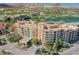 Picturesque aerial view showcasing a building, lush landscape, and a beautiful lake at 30 Strada Di Villaggio # 115, Henderson, NV 89011
