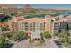 Stunning aerial view of a colorful building with a beautiful fountain and lush greenery landscape at 30 Strada Di Villaggio # 115, Henderson, NV 89011