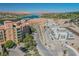 Aerial view of townhouses by a lake, with palm trees, mountains and construction work in the background at 30 Strada Di Villaggio # 115, Henderson, NV 89011