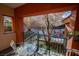 Private balcony overlooks a courtyard with trees and seating at 30 Strada Di Villaggio # 115, Henderson, NV 89011