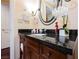 Bathroom with granite vanity and oval mirror at 30 Strada Di Villaggio # 115, Henderson, NV 89011