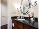 Bathroom with granite vanity, oval mirror, and towels at 30 Strada Di Villaggio # 115, Henderson, NV 89011