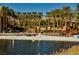Scenic beach area with lounge chairs, palm trees, and a tranquil waterfront at 30 Strada Di Villaggio # 115, Henderson, NV 89011