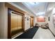 Hallway view showcasing elevators with seating, carpet, and wall decor at 30 Strada Di Villaggio # 115, Henderson, NV 89011