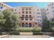 Elegant building exterior with balconies, arches, and manicured greenery at 30 Strada Di Villaggio # 115, Henderson, NV 89011