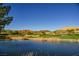 Scenic view of the golf course, featuring lush greenery, water features, and distant mountain views at 30 Strada Di Villaggio # 115, Henderson, NV 89011