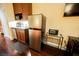 Small kitchenette with stainless steel appliances and wood cabinets at 30 Strada Di Villaggio # 115, Henderson, NV 89011