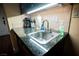 Dark granite countertop kitchenette with sink and appliances at 30 Strada Di Villaggio # 115, Henderson, NV 89011