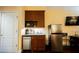 Small kitchenette with wood cabinets and modern appliances at 30 Strada Di Villaggio # 115, Henderson, NV 89011