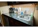 Granite countertop kitchenette with sink, coffee maker, and utensils at 30 Strada Di Villaggio # 115, Henderson, NV 89011