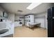 Clean laundry room with washers, dryers, folding tables, and laundry supplies at 30 Strada Di Villaggio # 115, Henderson, NV 89011