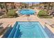 Inviting community pool and spa with comfortable lounge area and ample sunshine at 30 Strada Di Villaggio # 115, Henderson, NV 89011