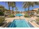 Beautiful community pool and spa surrounded by palm trees and lush landscaping at 30 Strada Di Villaggio # 115, Henderson, NV 89011