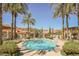 Inviting resort-style pool with palm trees and relaxing atmosphere at 30 Strada Di Villaggio # 115, Henderson, NV 89011