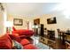 Studio apartment with red couch, bed, and kitchenette at 30 Strada Di Villaggio # 115, Henderson, NV 89011