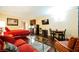 Studio apartment with red couch, bed, and kitchenette at 30 Strada Di Villaggio # 115, Henderson, NV 89011