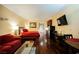 Studio apartment with red couch, bed, and kitchenette at 30 Strada Di Villaggio # 115, Henderson, NV 89011