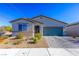 Single-story home with a teal garage door at 3556 Valley Lily St, North Las Vegas, NV 89032