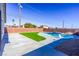 Inviting kidney-shaped pool with artificial turf at 3556 Valley Lily St, North Las Vegas, NV 89032